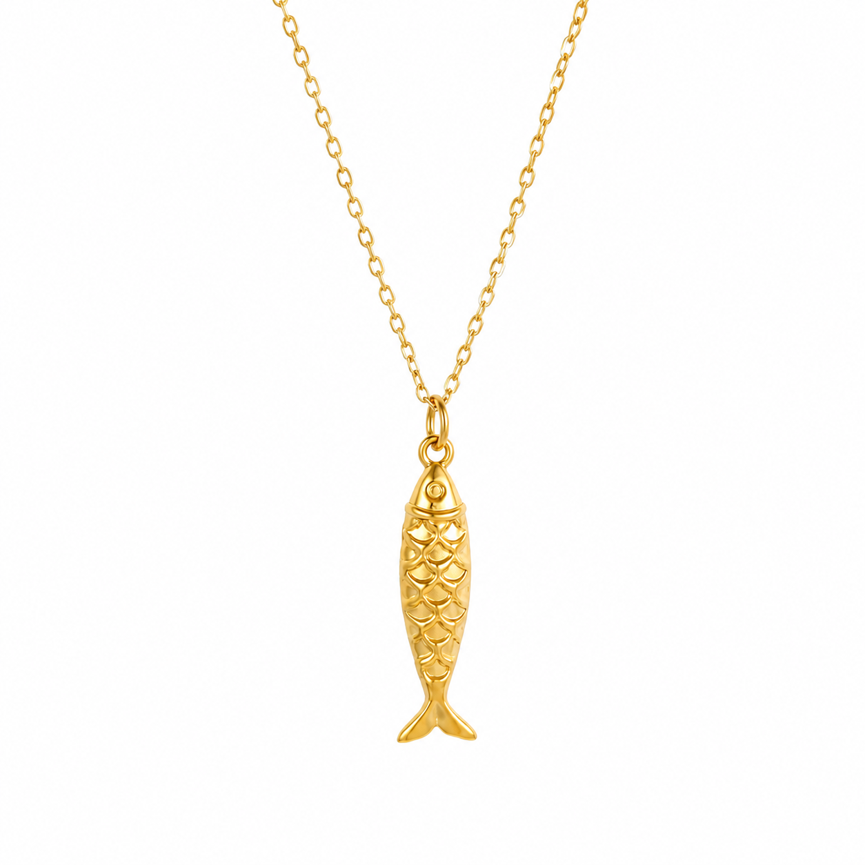 A gold fish-shaped pendant necklace on a delicate gold chain, shown against a plain white background.