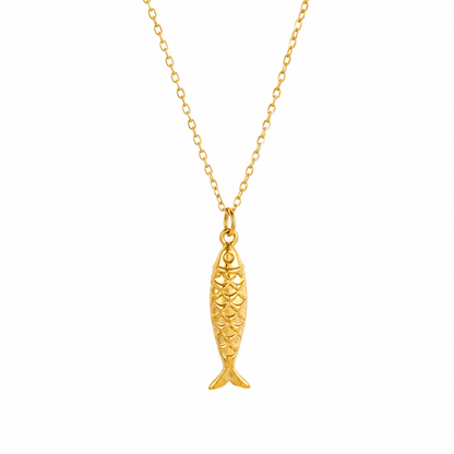 A gold fish-shaped pendant necklace on a delicate gold chain, shown against a plain white background.