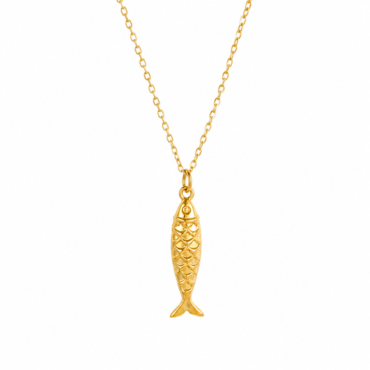 A gold fish-shaped pendant necklace on a delicate gold chain, shown against a plain white background.