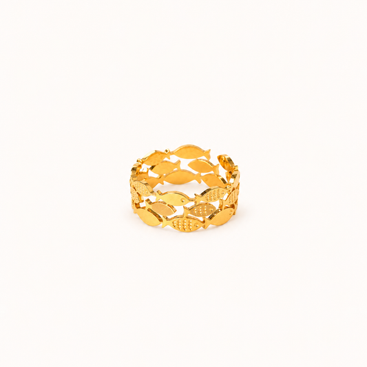 A gold-colored waterproof adjustable ring featuring a continuous pattern of fish, displayed on a clean, solid off-white background.