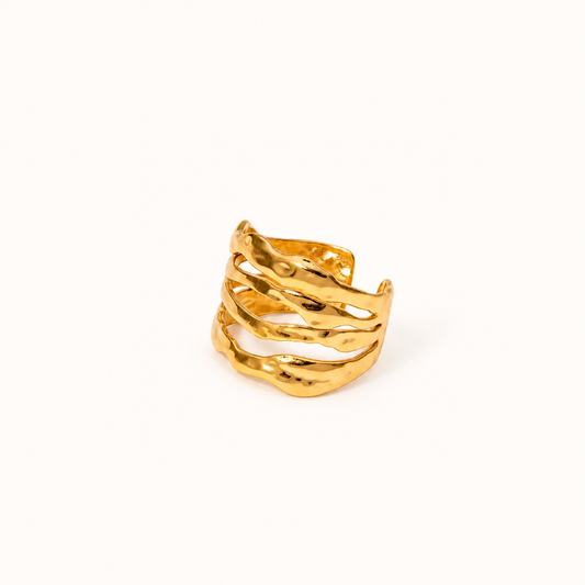 A gold-toned multi-band cuff ring with a hammered, organic wavy texture, photographed on a clean, solid off-white background. wavy adjustable waterproof multi layered 18k gold plated stainless steel adjustable ring